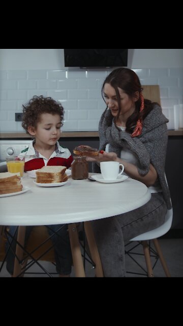 Happy Toddler child- having breakfast with women