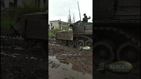 Ukrainian soldiers work on retreiving a broken tank