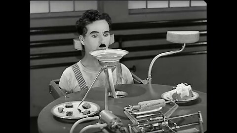 Charlie Chaplin with feeding machine