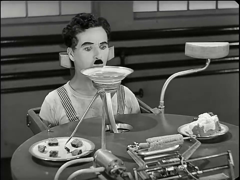 Charlie Chaplin with feeding machine