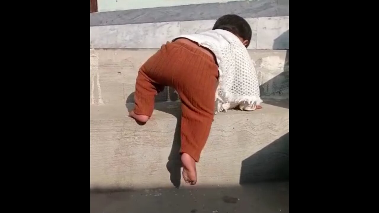 Cute baby first attempt to climbing up stairs