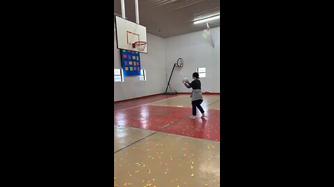 Hitting a volleyball into a basketball net with my head
