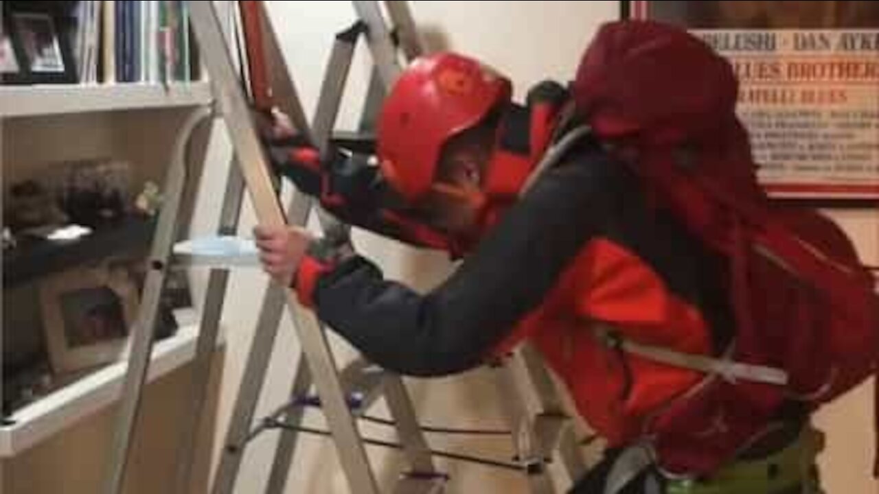 Climber cleans house wearing full gear