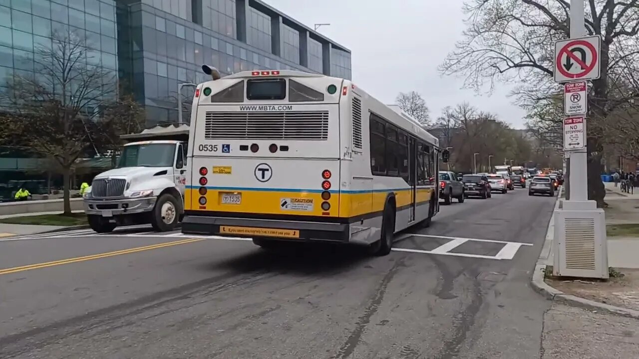 MBTA bus 0535 driving down the street with horns blaring