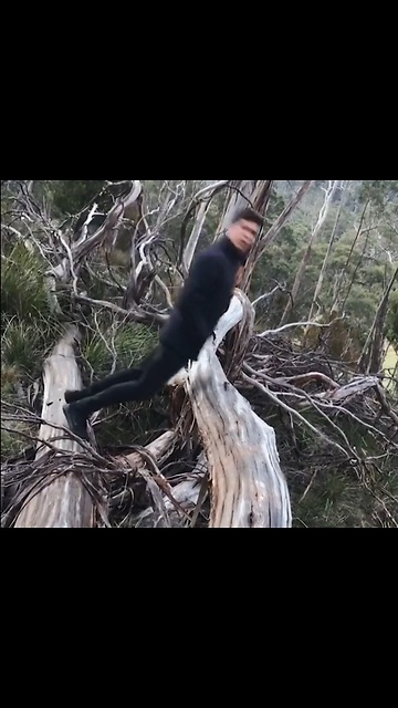 Guy Does A Flip Over A Log With Hands In His Pocket