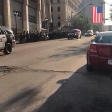 Procession carrying fallen Officer Michael Michalski passes through downtown