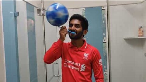 Man balances soccer balls bizarrely