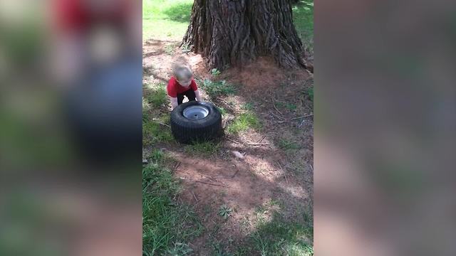Tot Boy Helps His Father To Change A Broke Tire
