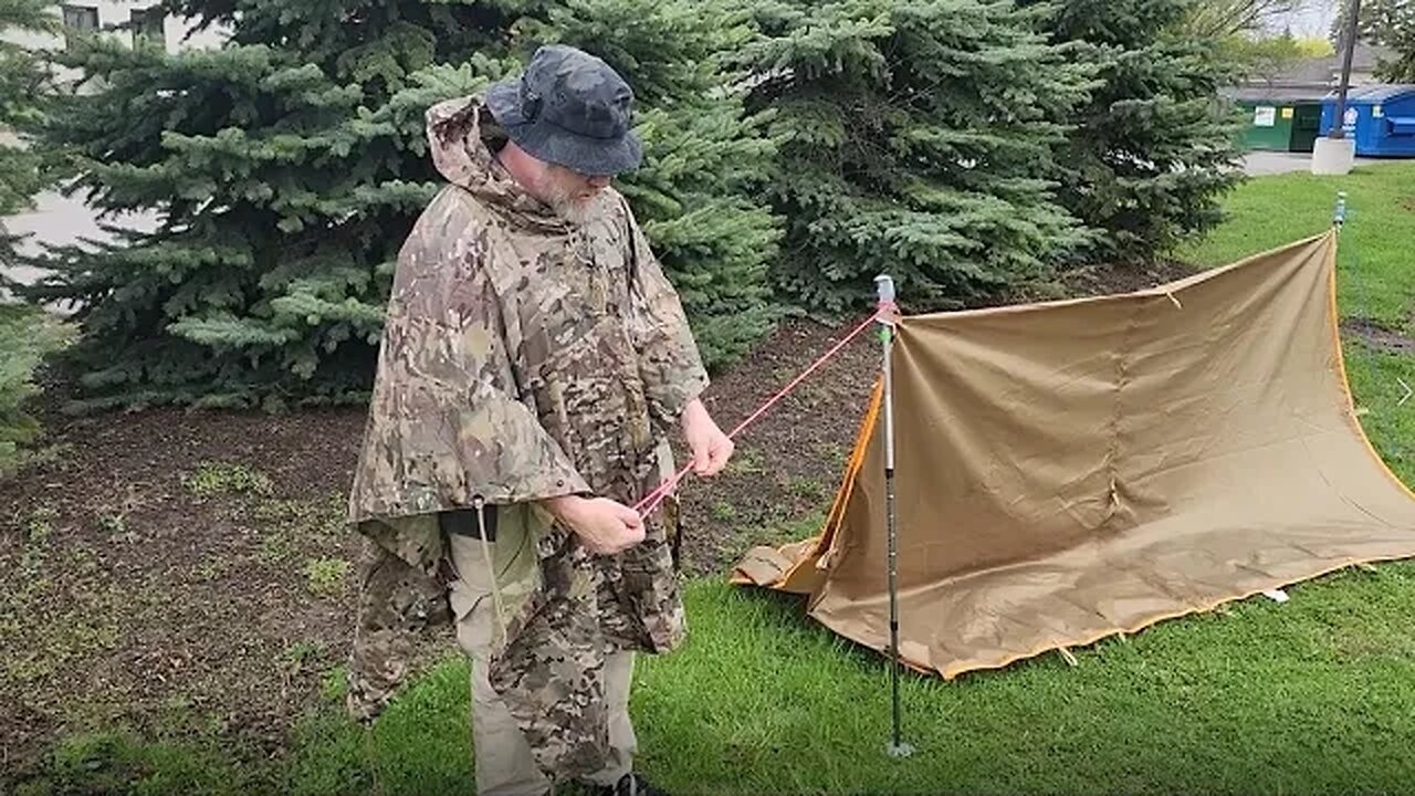 A frame tarp with trekking poles