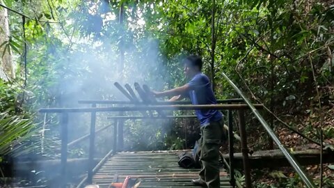 Building a bamboo shelter on a rock face:16