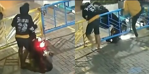 Two thieves stealing the scooter.