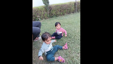 Twins baby playing with water