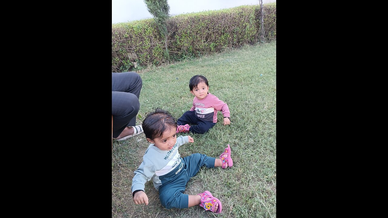 Twins baby playing with water