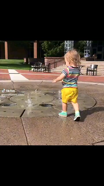 Splash Fun joyful toddler playing with water, their face beaming with excitement as they splash