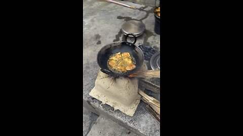 Frying fish at village