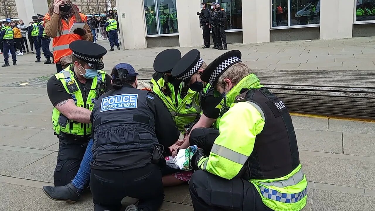 Riot police pin down woman as she is arrested