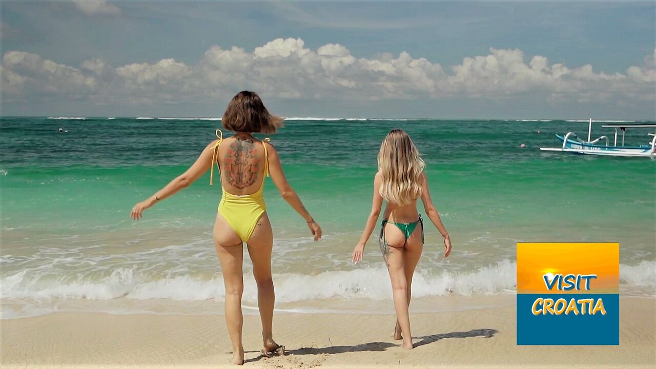 Women Walking On Sand Beach