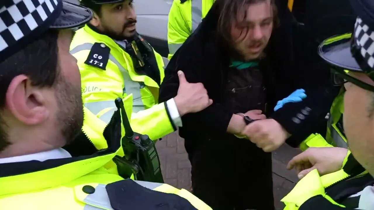 male protester carried by arms and legs vaxuall bridge #metpolice