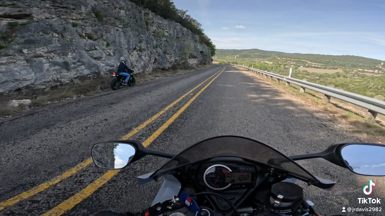 Biker hits guardrail.