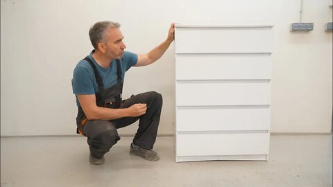 Antique restorer restores a cheap laminate dresser