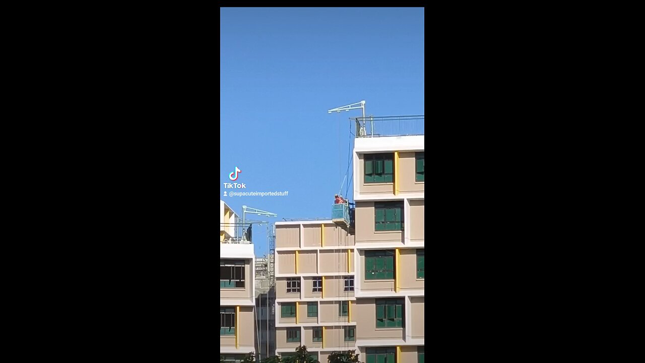 Construction Workers on the side of an Unfinished HDB Block in Singapore
