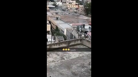 Israeli soldiers throwing a blindfolded Palestinian from a roof