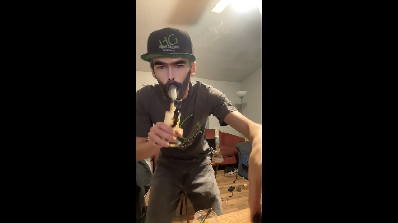 Yung Alone with a fat dab while wearing Home Grown Dispensary Merch