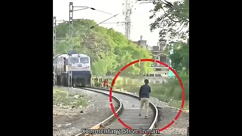 Unhinged man tries to block a train and gets smacked