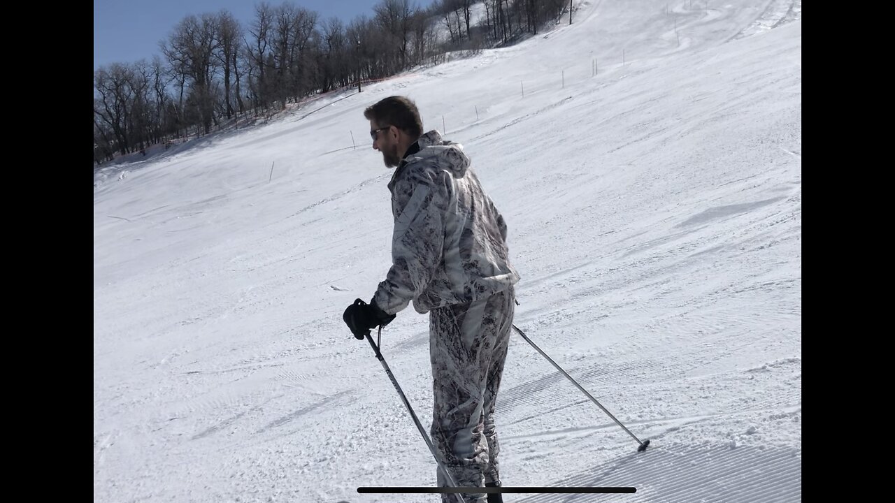 Dad skis in his hunting camo