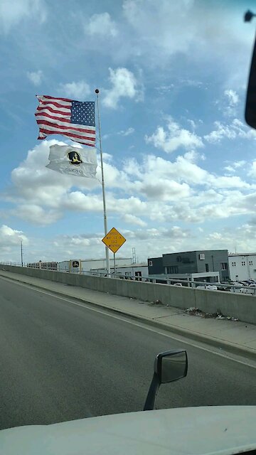 Giant John Deere flag on a windy day in Dallas Texas