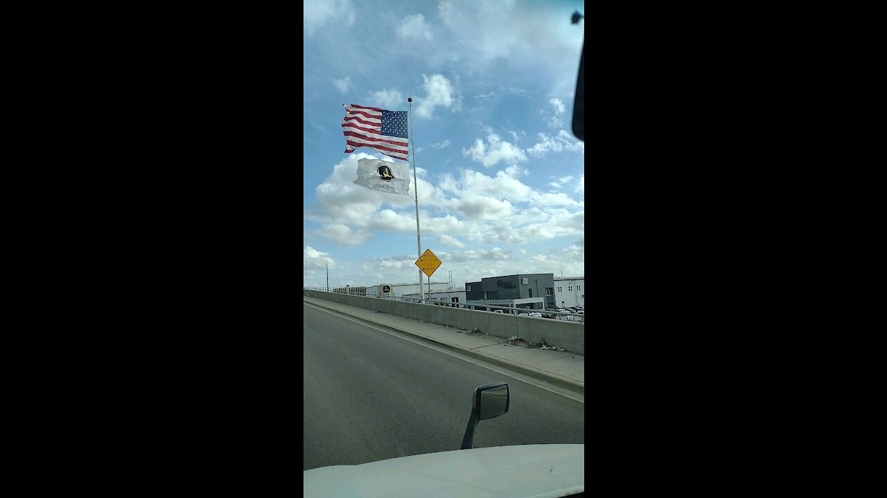 Giant John Deere flag on a windy day in Dallas Texas