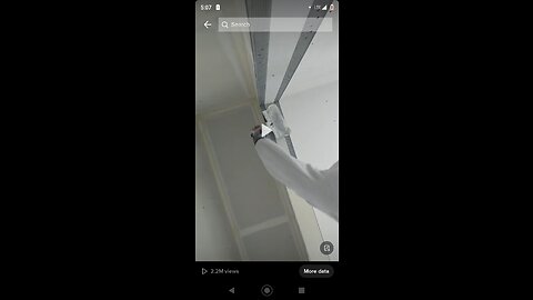 Drywall finisher putting mud on a corner beat of a closet