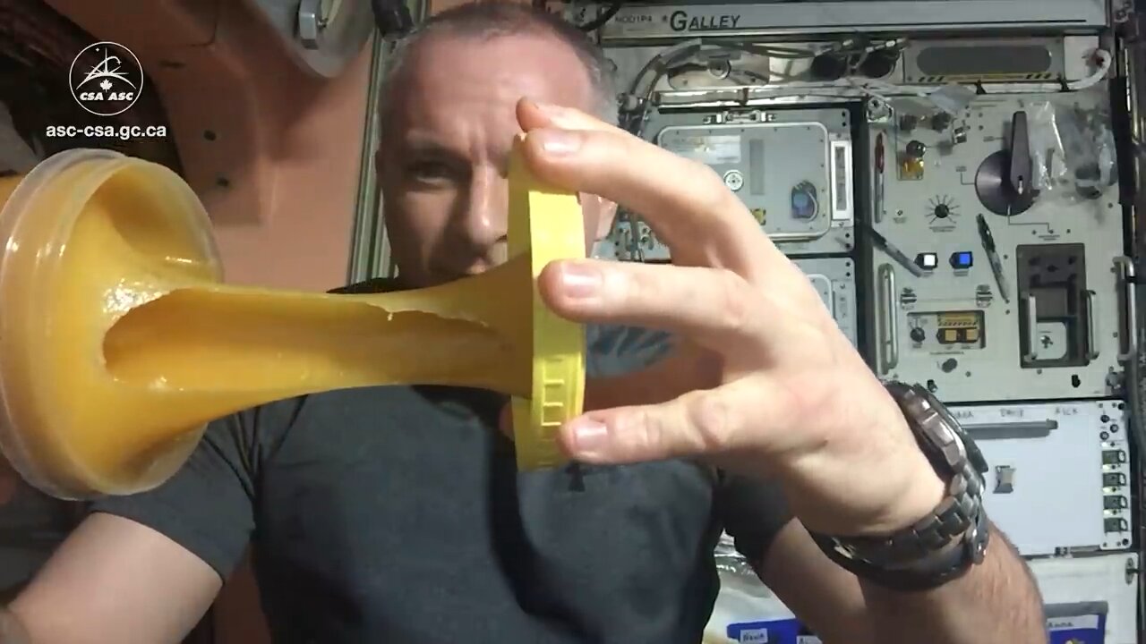 Nasa astronaut playing with honey in space