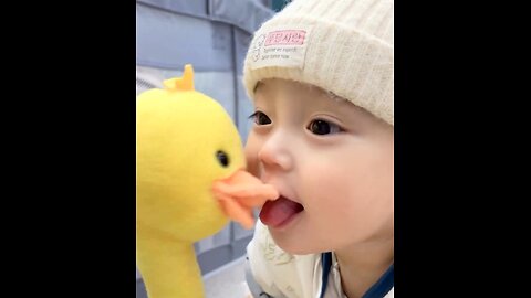 Cute little baby and duckling