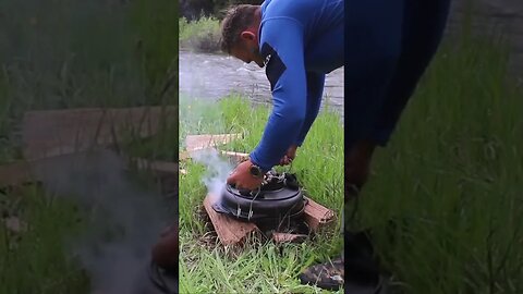 Camp fire cooking a pizza in the Wyoming wilderness. Dutch over pizza