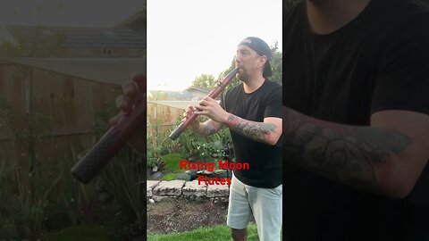 Playing Native American Flute by a water feature