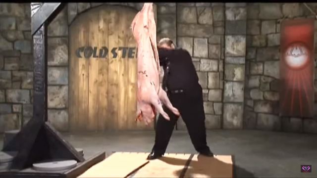 man chopping pork with katana