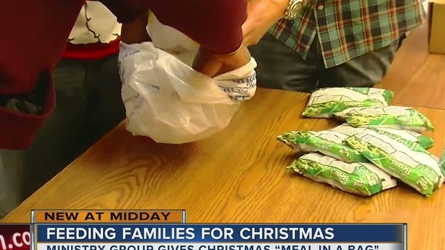 Families in need receive Christmas Meal-In-A-Bag for their holiday dinners this weekend