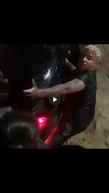 Man saves woman and her baby from a stuck car in a flooded street in Brazil