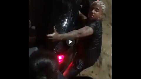 Man saves woman and her baby from a stuck car in a flooded street in Brazil