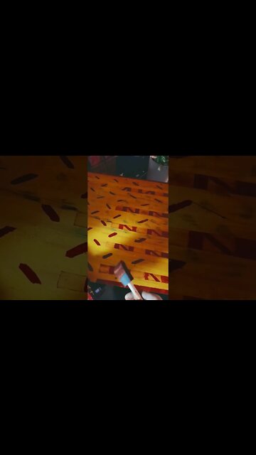 What is the Story by puttimg tape over Red then blottimg out back to orange but not under the tape