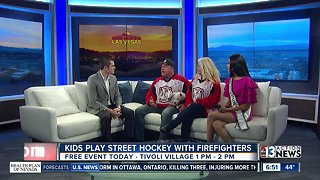 Kids play street hockey with firefighters