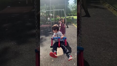 Baby girl is swing her baby brother-loads of happiness in the park