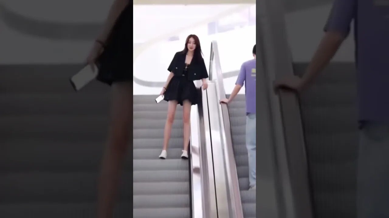 Chinese Girl Makes A Play On An Escalator