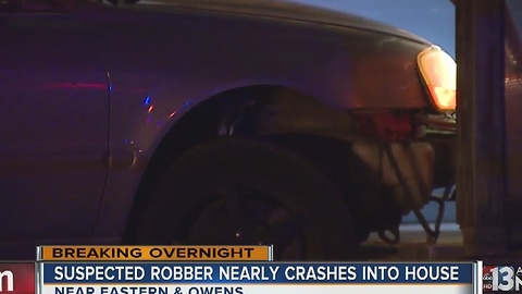 Robbery suspect crashes into woman's house