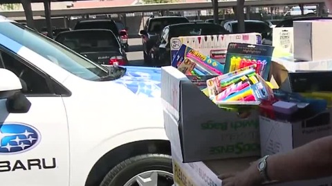 Donations brought to vehicles for Supplies for Success Drive