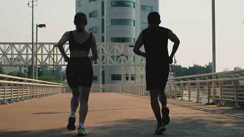 Man and woman jogging together on the street