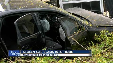 Stolen car slams into home, police searching for suspects