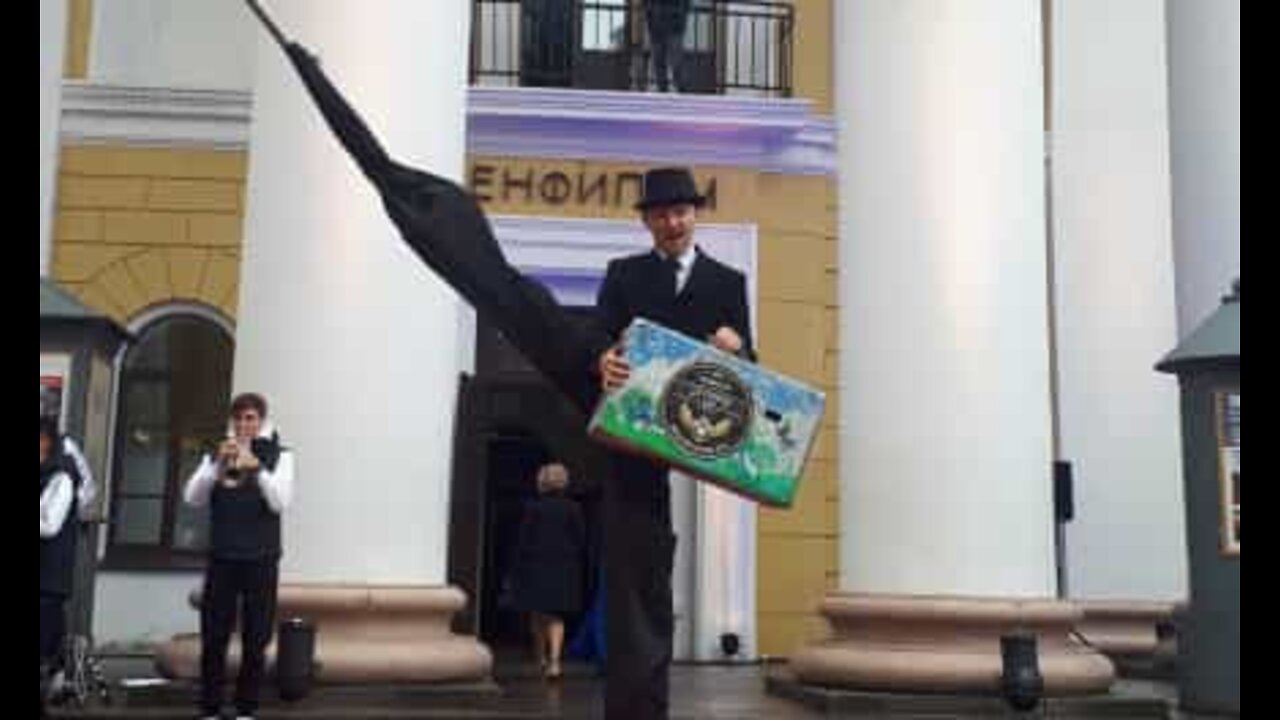 Stilt walker stumbles on red carpet