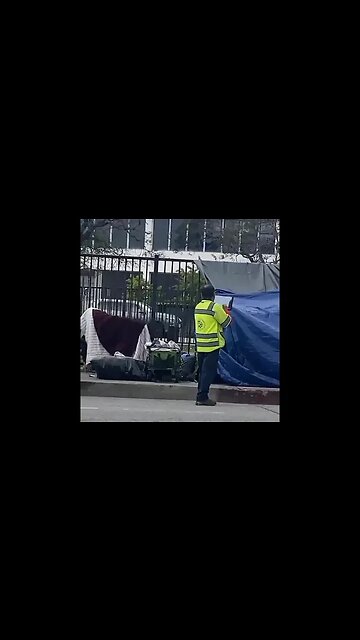 Los Angeles: What is the sanitation worker doing?